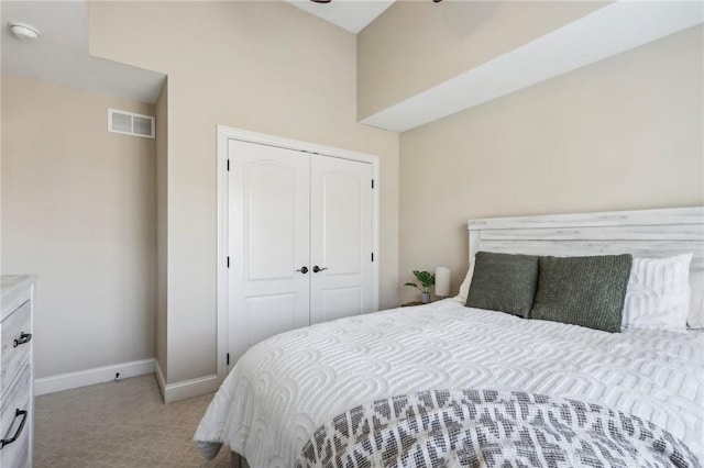 bedroom with light carpet and a closet