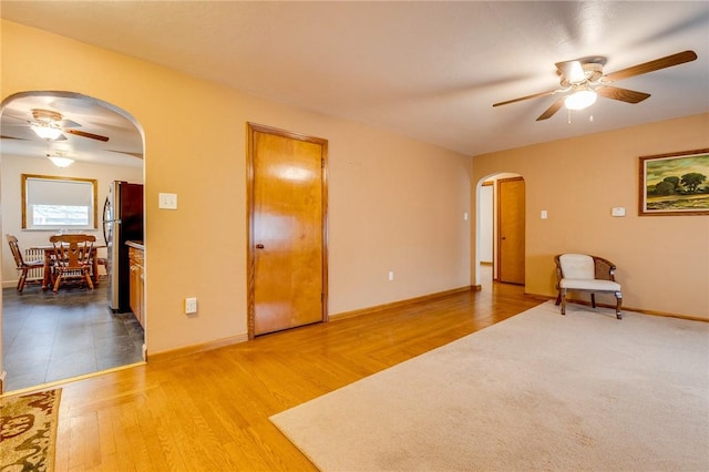 unfurnished room with ceiling fan and light wood-type flooring