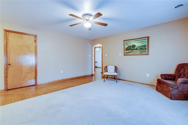 sitting room featuring ceiling fan and light carpet