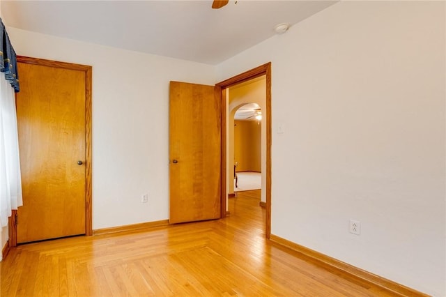 unfurnished bedroom featuring hardwood / wood-style floors and ceiling fan