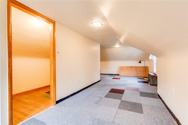 additional living space featuring vaulted ceiling