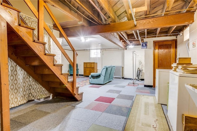 basement with radiator and washing machine and clothes dryer