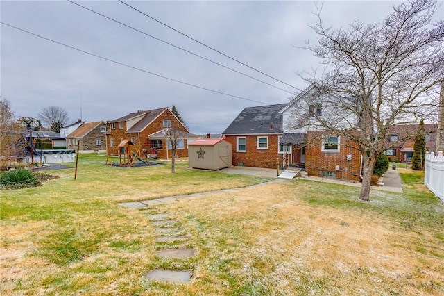 view of yard with a shed and a playground