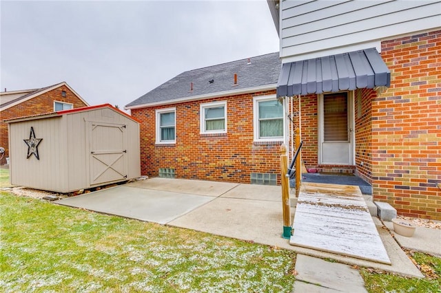 rear view of property featuring a patio and a storage unit