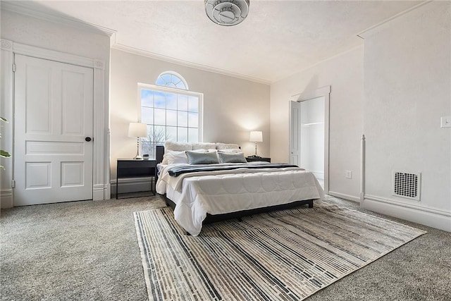 bedroom featuring crown molding, carpet floors, and a textured ceiling