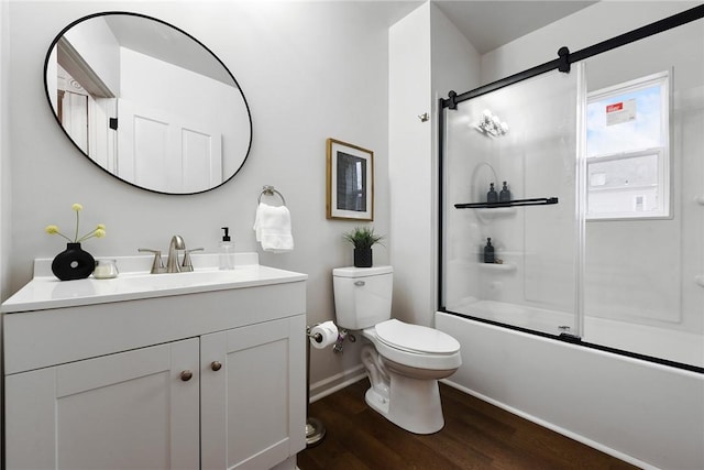 full bathroom featuring vanity, bath / shower combo with glass door, toilet, and wood-type flooring