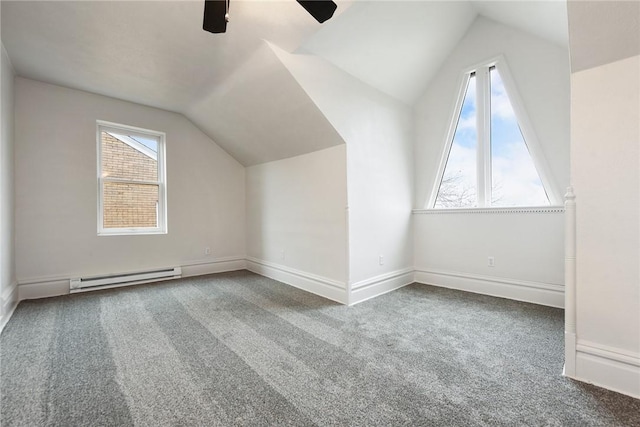 additional living space with ceiling fan, carpet floors, vaulted ceiling, and baseboard heating