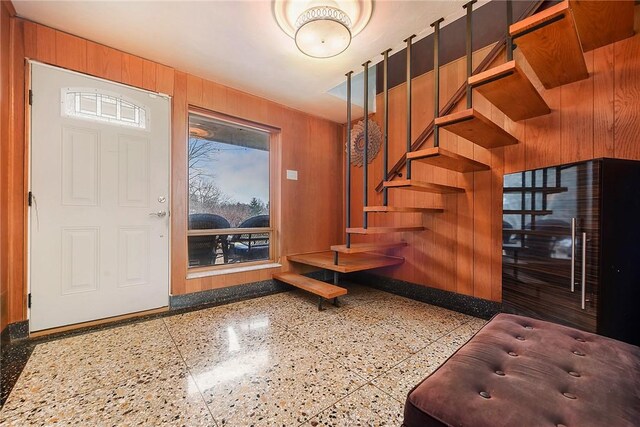 entryway with wood walls