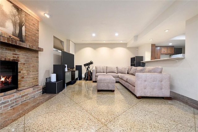 living room featuring a brick fireplace