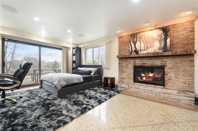 bedroom with access to exterior and a fireplace