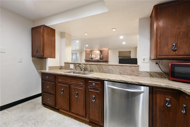 kitchen featuring dark brown cabinets, sink, stainless steel dishwasher, and light stone counters