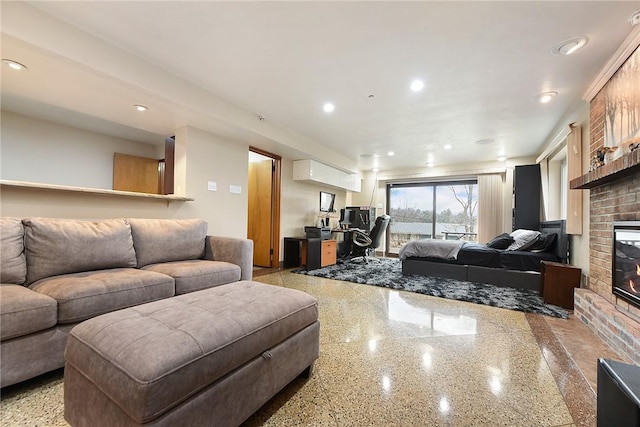 living room with a brick fireplace