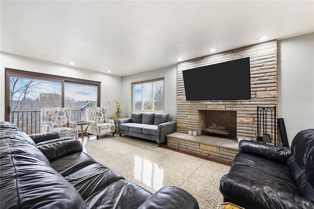 living room featuring a fireplace and plenty of natural light