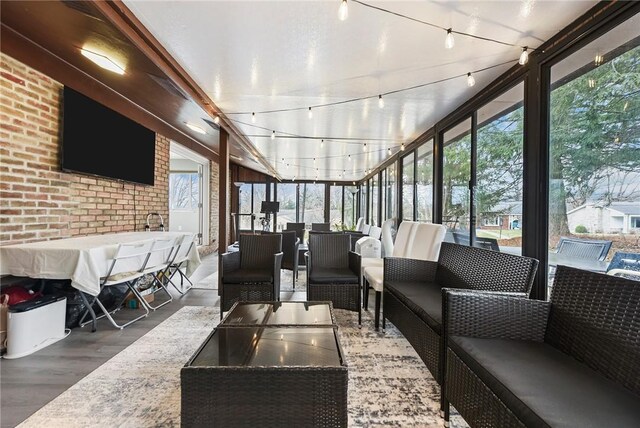 sunroom with track lighting and a healthy amount of sunlight