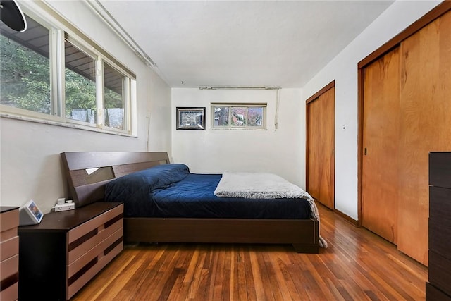 bedroom with dark hardwood / wood-style flooring