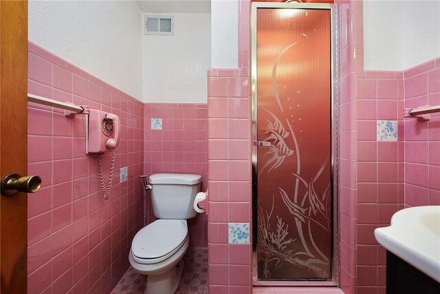 bathroom with toilet and tile walls