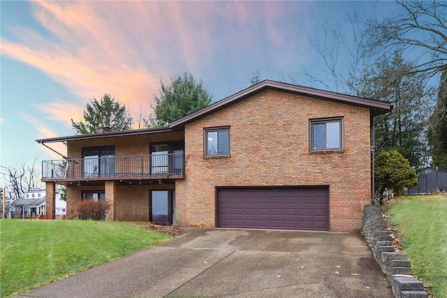 view of front of property featuring a balcony, a garage, and a lawn