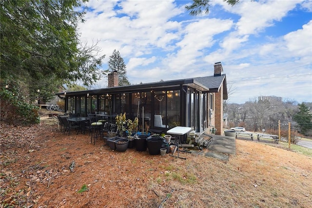 back of house featuring a sunroom