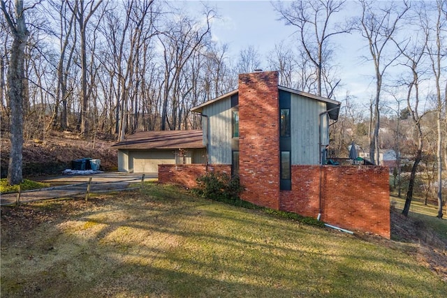 view of home's exterior with a garage and a yard