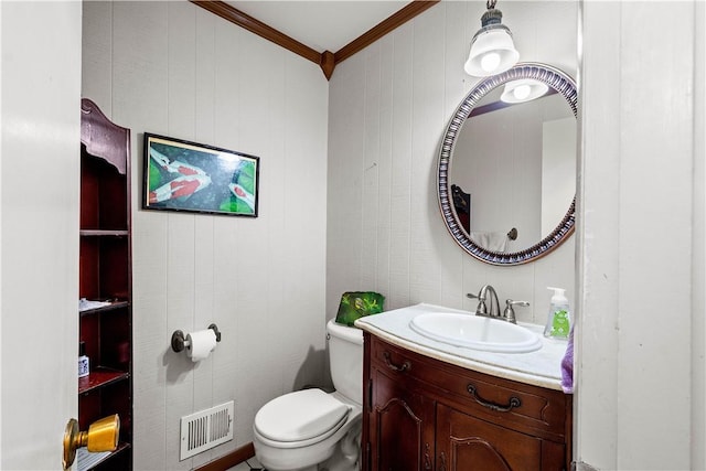 bathroom with ornamental molding, toilet, and vanity