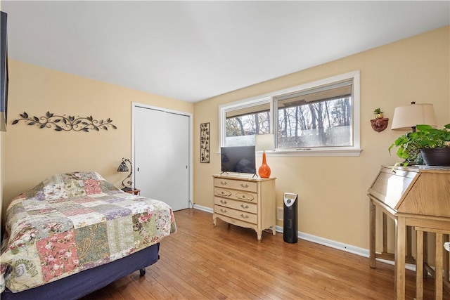 bedroom with a closet and light hardwood / wood-style flooring