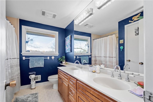 bathroom featuring vanity, tile patterned floors, and toilet