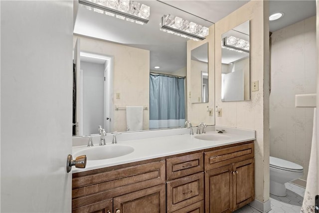 bathroom with vanity, tile patterned flooring, and toilet