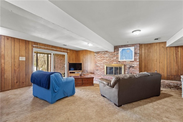 carpeted living room featuring a brick fireplace, beamed ceiling, and wood walls