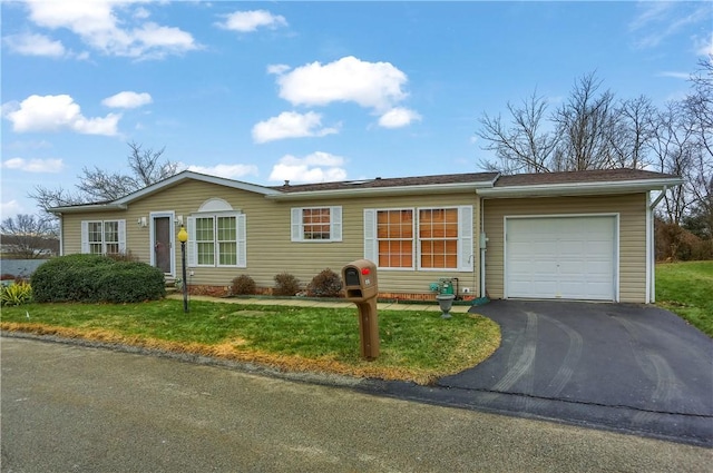 ranch-style home with a garage and a front lawn