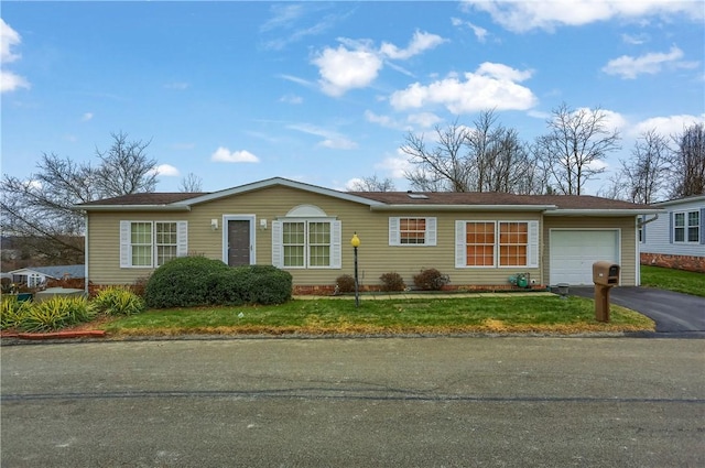 single story home with a garage and a front yard