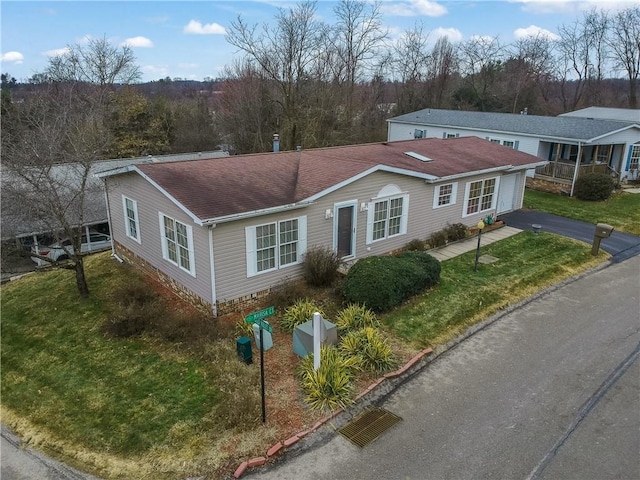 ranch-style home with a front lawn