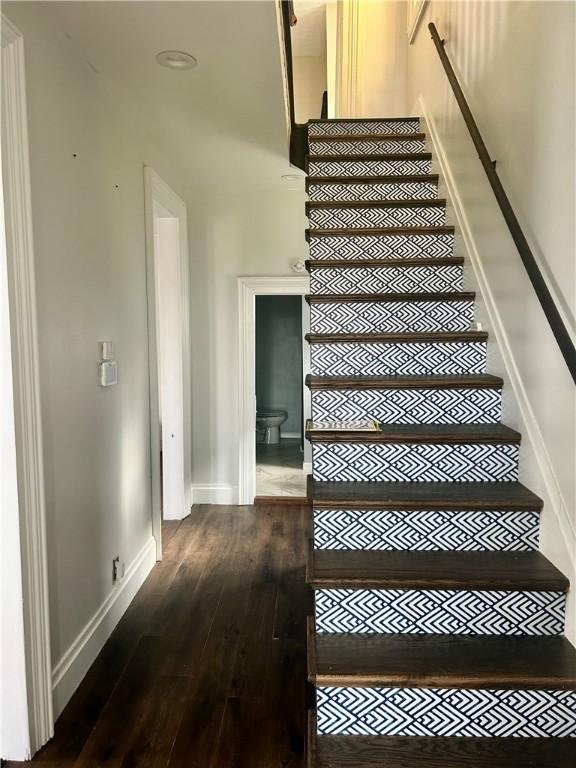 stairs featuring wood-type flooring