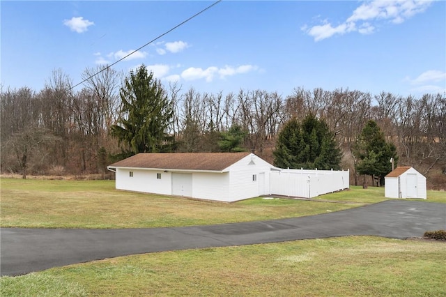 view of home's exterior featuring a storage shed and a yard