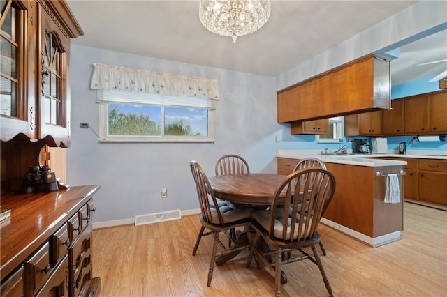 dining room featuring an inviting chandelier and light hardwood / wood-style floors