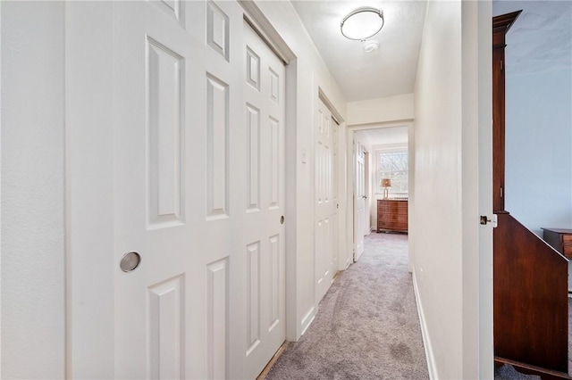 hallway featuring light colored carpet