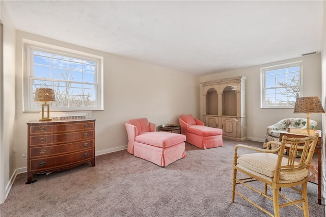 sitting room featuring light colored carpet