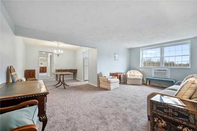 carpeted living room featuring a notable chandelier and an AC wall unit