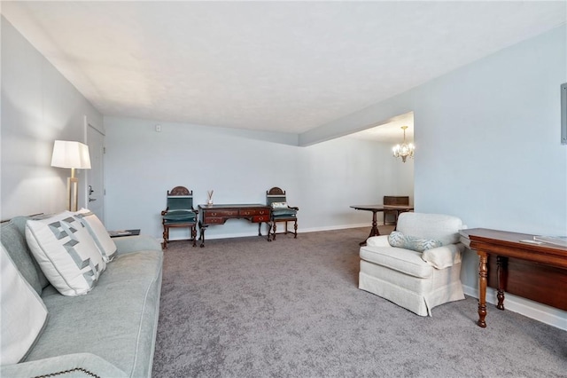 carpeted living room with a chandelier