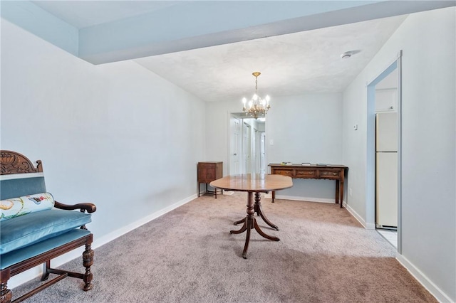 sitting room with light colored carpet and a chandelier