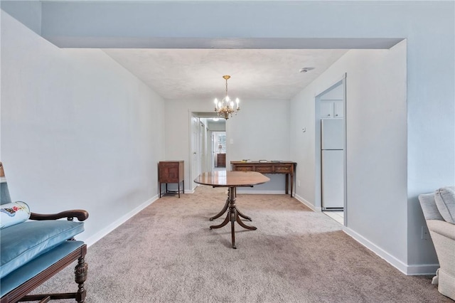 dining room with an inviting chandelier and light colored carpet