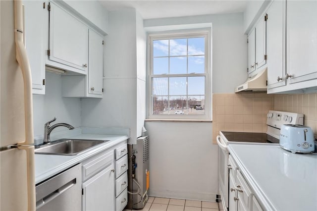 kitchen with sink, white appliances, white cabinets, and backsplash