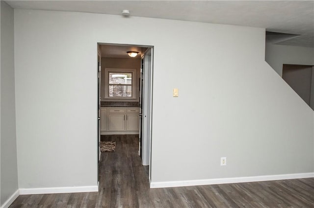 hallway with dark hardwood / wood-style floors