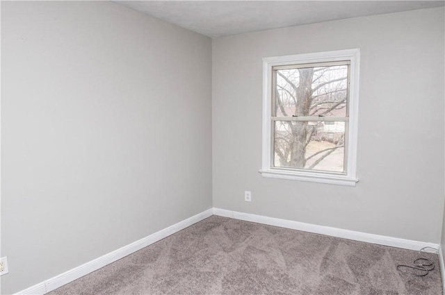 spare room featuring light carpet