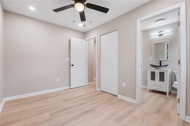 bedroom featuring ceiling fan, a closet, and light hardwood / wood-style flooring