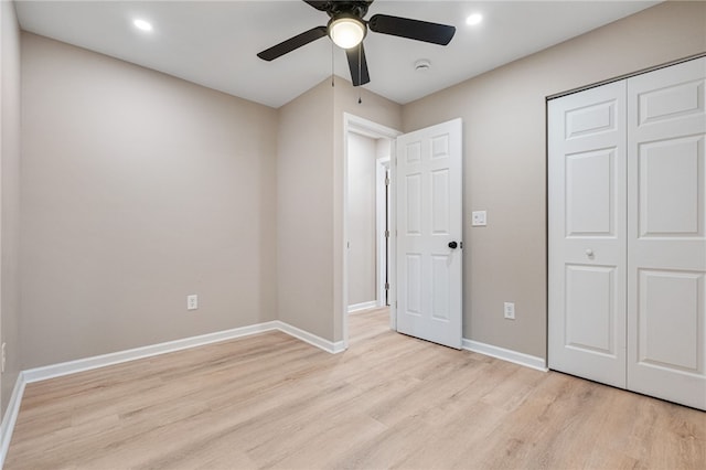 unfurnished bedroom with ceiling fan, light hardwood / wood-style floors, and a closet