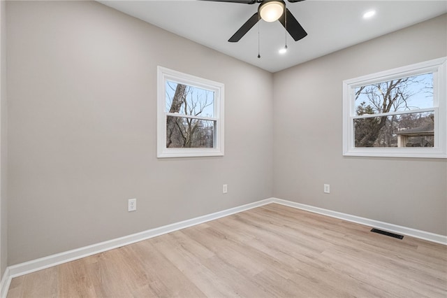 spare room with light hardwood / wood-style flooring and ceiling fan