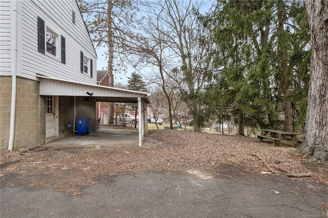 view of yard with cooling unit and a carport