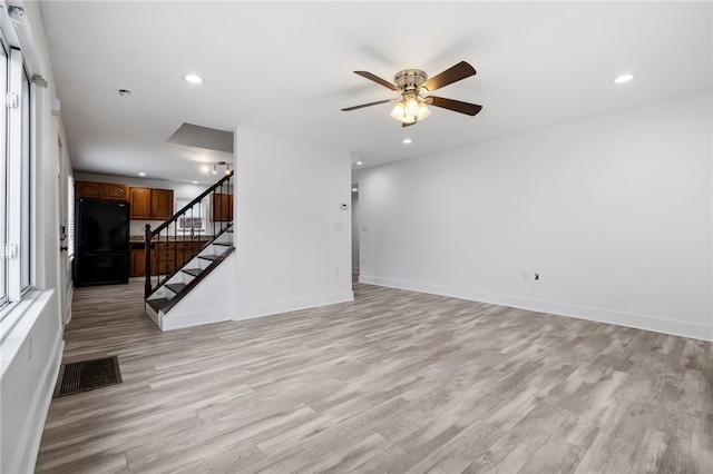 unfurnished living room with stairs, recessed lighting, visible vents, and light wood-style floors