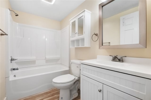 bathroom featuring bathtub / shower combination, vanity, toilet, and wood finished floors