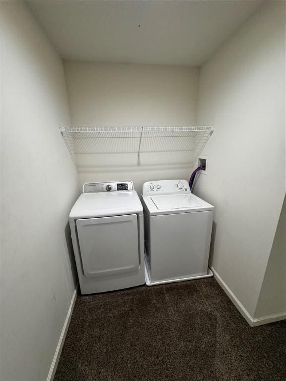 washroom featuring dark colored carpet and washing machine and dryer